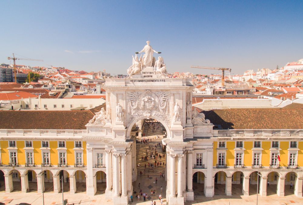 The stunning Rua Augusta Arch in Lisbon's bustling downtown, showcasing Lisbon Tourist Attractions with its historical architecture and vibrant city life.