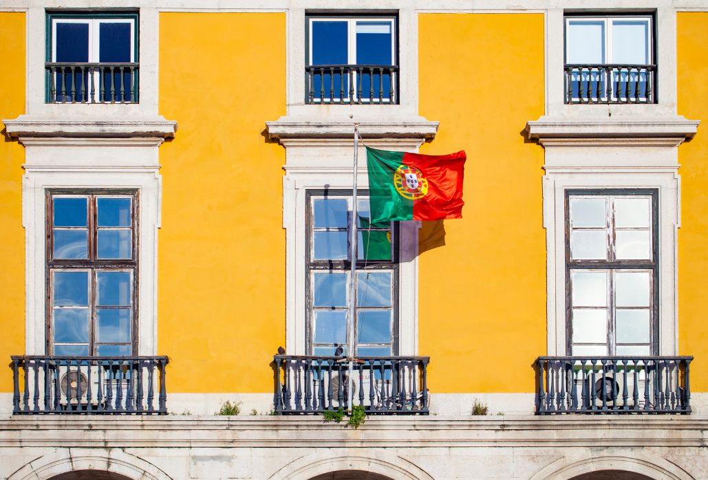 Portuguese Flag In The Praca Do Comercio Of Lisbon, (the best time to visit Portugal)